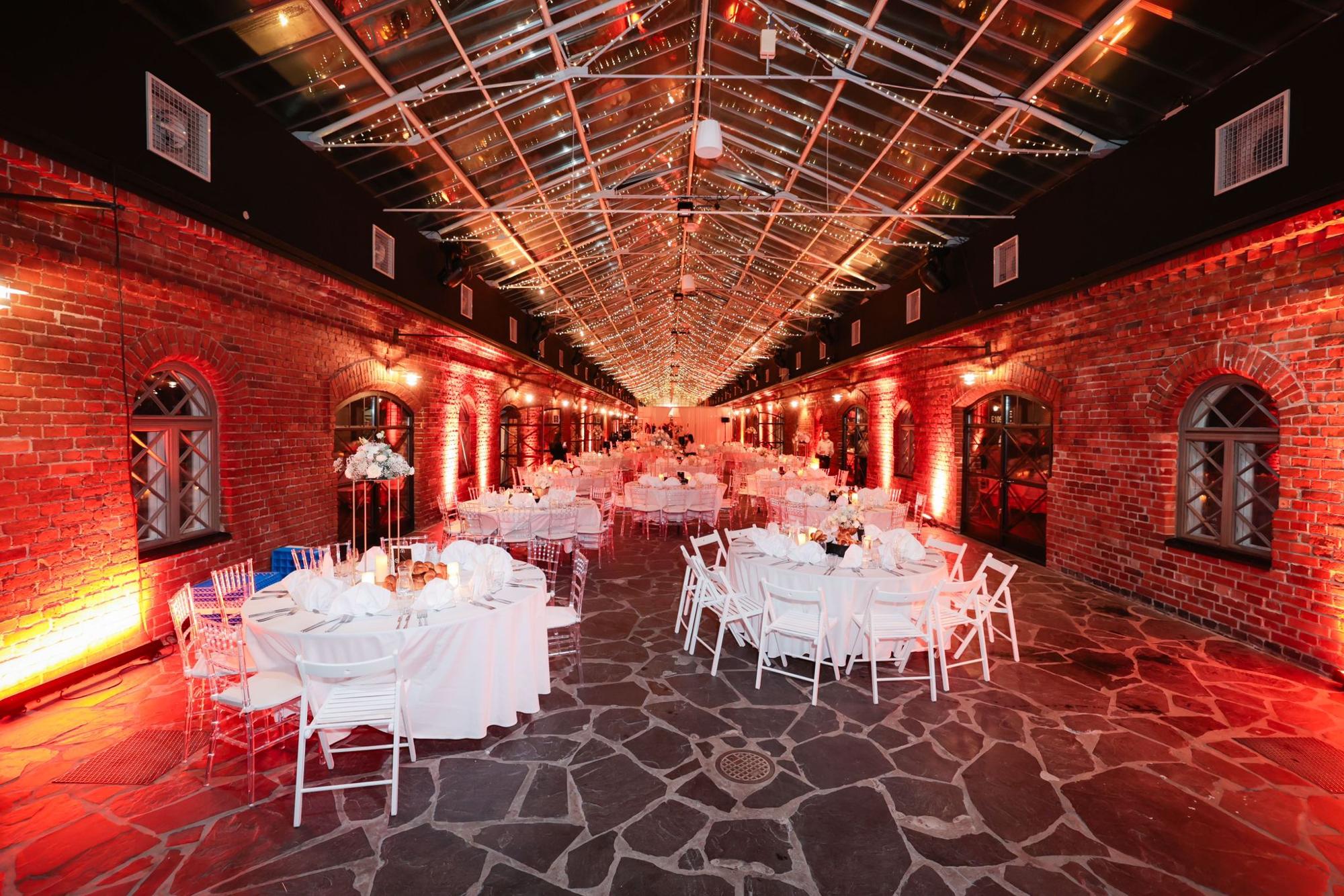 A reception hall lit in deep red